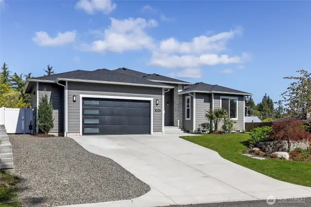 The two-car garage is enhanced with a 5-foot bump, and includes Safe Rack mounted storage, a motion activated ventilation fan, utility sink, tankless water heater, and a utility door to the side yard.  There is additional parking space available as well.