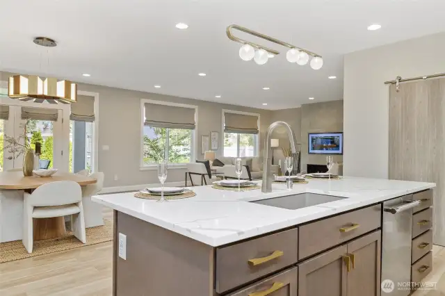 The ease of entertaining extends effortlessly from the kitchen to the adjacent dining and living rooms, creating a cohesive and welcoming space for gatherings of any size.