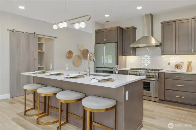 The kitchen's meticulous design includes desirable features such as soft-close drawers and cabinets, a handy spice rack, integrated USB ports for modern convenience, and stylish custom lighting.