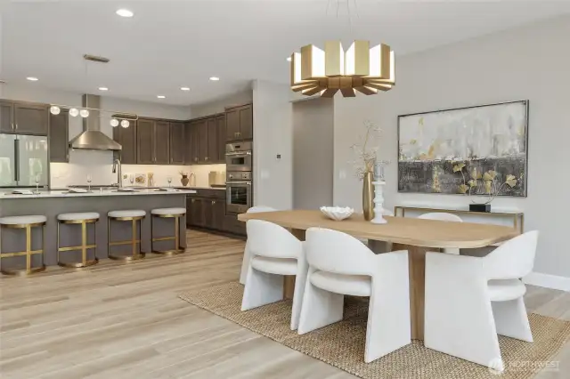 The dining room is graced by a stunning lighting fixture, truly a work of art that elevates the entire space.