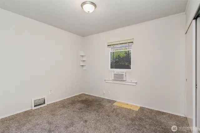 Bright and inviting guest bedroom with ample space and a sizable closet.