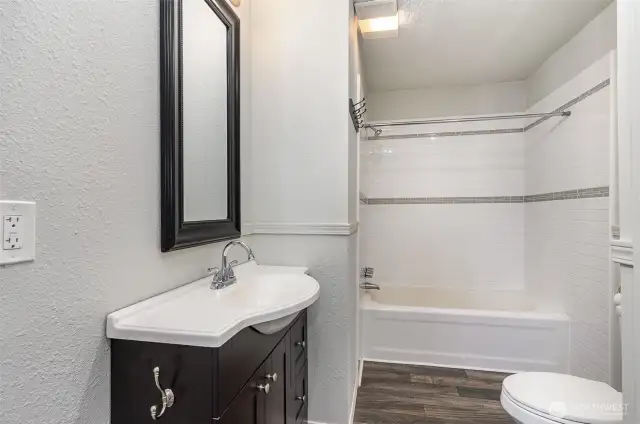 Main bathroom featuring modern fixtures, ample storage space, and a clean, functional layout perfect for family use.