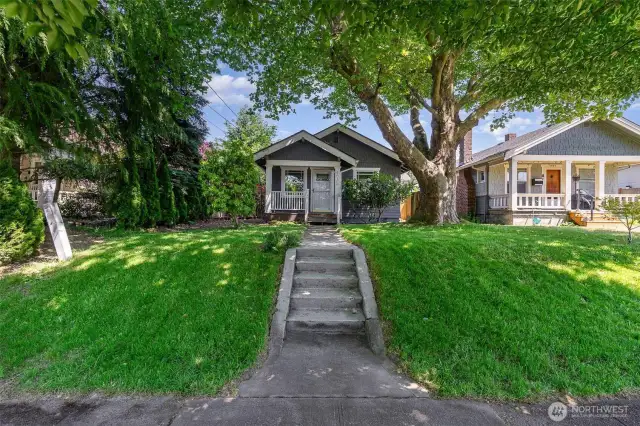 Enjoy great curb appeal with a welcoming walkway, mature front-yard tree & a cozy covered porch—perfect for relaxing.