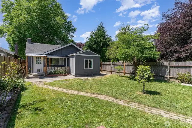 The spacious yard offers room to play, garden, or entertain.