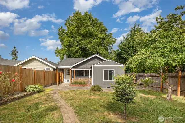 The spacious yard offers room to play, garden, or entertain.
