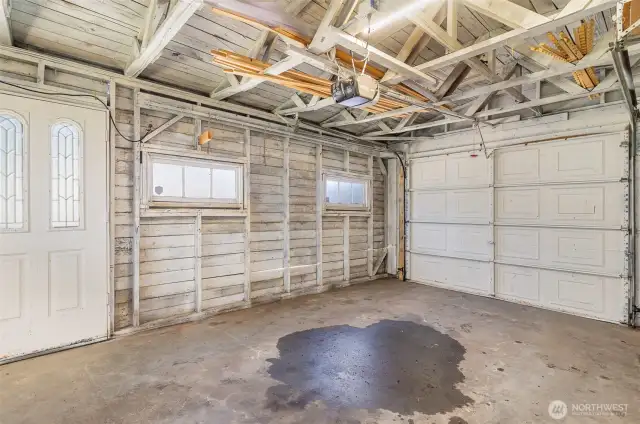 Detached single-car garage provides secure parking or extra storage space, accessible from alley