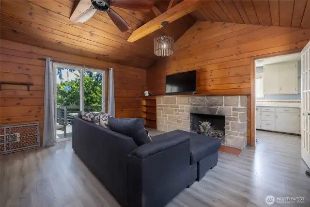 Glass slider leads out to the lovely composite deck. Wood burning fireplace with built in shelves.