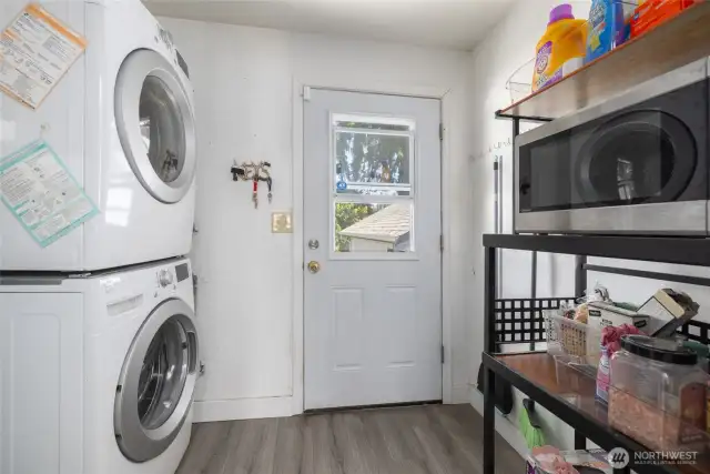 Area for washer / dryer inside at rear entrance.