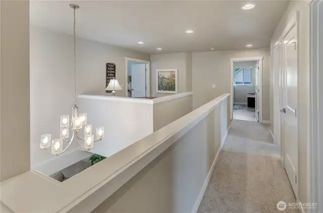 Wide hallways and foyer landing outside Primary Bedroom provide separation from the other bedroom wing of this home.