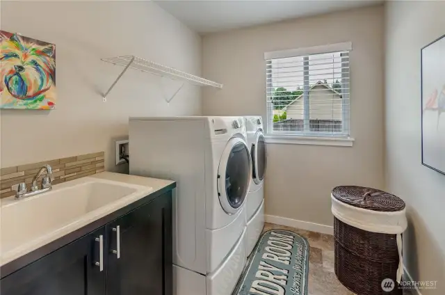 Upstairs laundry room has natural light, storage and an upstairs coveted laundry room sink! It's close to where the dirty clothes are.