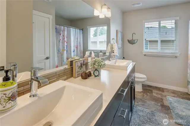 Tile flooring, Artisian designed Vessel sinks, new hardware makes this full bathroom stylish and functional.