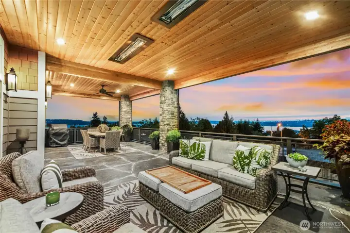 Electronic patio shades drop down to make this an all season space.