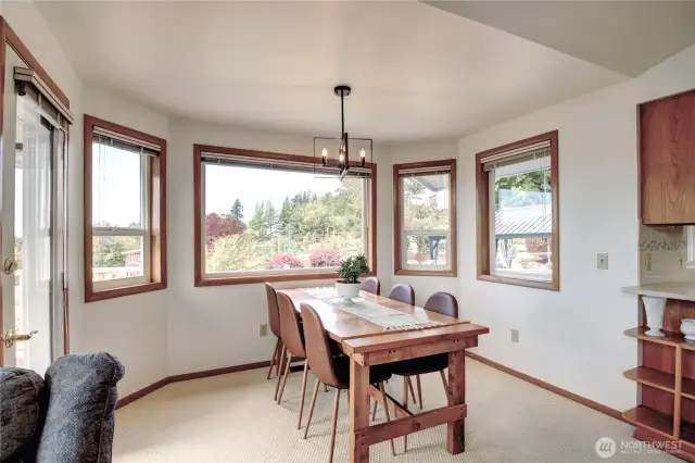 The dining area has access to he wrap around deck and views to the west and south.