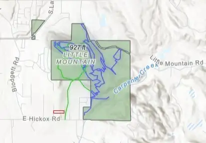 The property is shown in red.The trails are highlighted in green and blue.