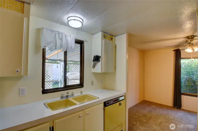 Kitchen with window facing the car port