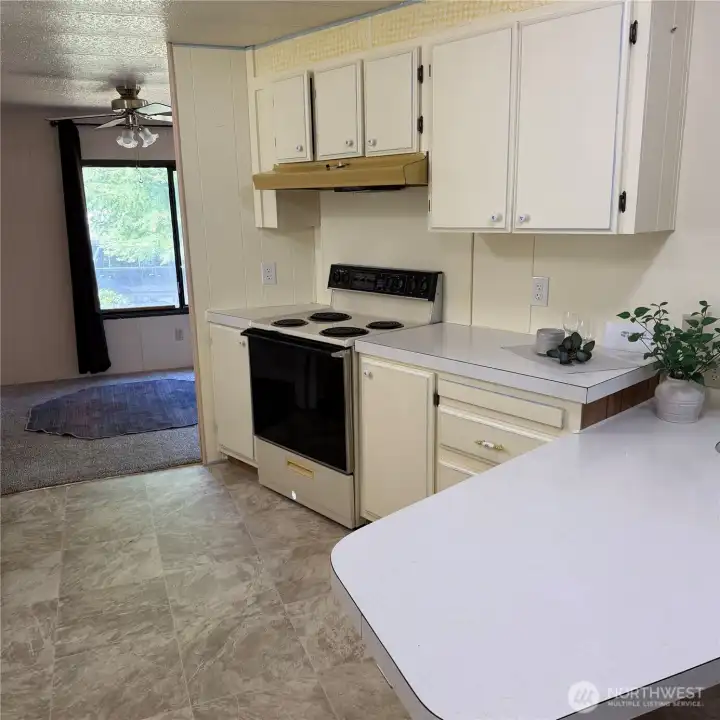 Kitchen with window facing the car port