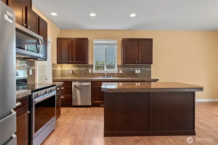 Granite tile counters with large island and eating bar