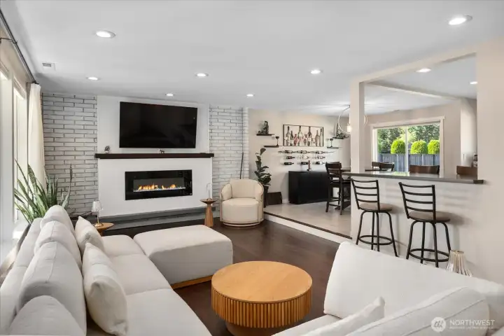 Sunken living room with a Burn Brite fireplace with masonry surround, strand-woven bamboo flooring, and recessed lighting.
