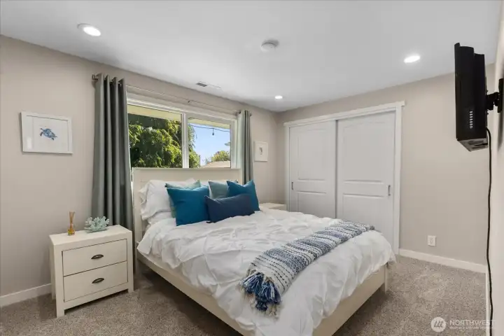 Bedroom two with ceiling fan, craftsman trim, and 2-panel doors. Motion sensor lighting in the closet.