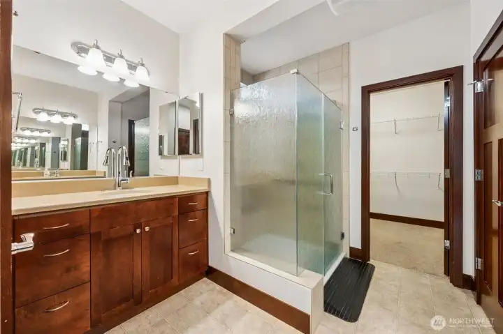 2nd of two vanities in this primary bathroom. Here you see one side near the walk in shower with all new gorgeous glass shower doors! The large closet is plenty spacious for one, OR two if maybe you are willing to share and still have plenty of room. ;)