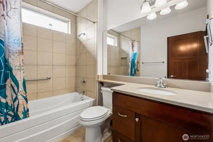 2nd full sized bathroom. Big window but still private! Next to the front bedroom on opposite end of the home for extra privacy for everyone.