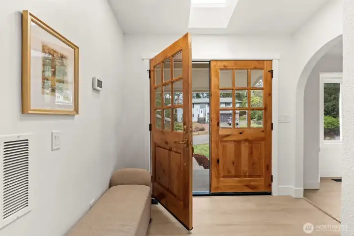 Step into a sanctuary of light. This stunning entryway features a centerpiece skylight that transforms the foyer into an ever-changing gallery of shadows and brilliance throughout the day.