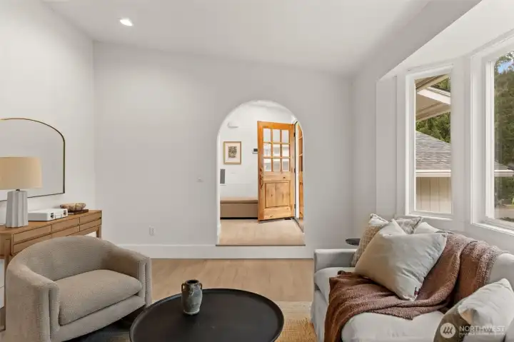 Architectural elegance takes center stage where the grand living room meets a masterfully crafted arched transition.