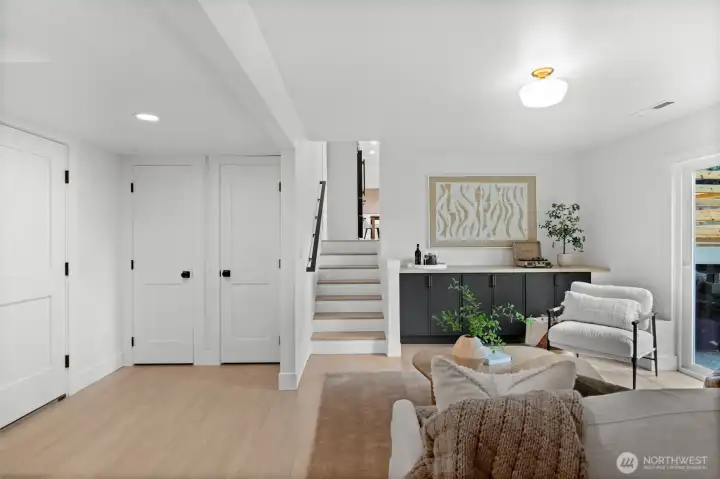 A masterfully zoned bottom level that maximizes the home’s footprint. This level integrates a high-capacity mudroom with a sophisticated secondary living area, offering a versatile environment from the garage or kitchen.