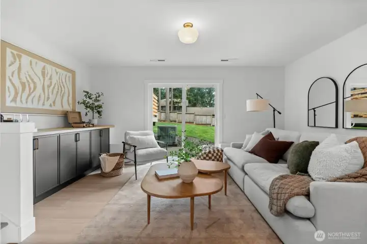 Maximizing indoor-outdoor living, this secondary living room is anchored by it's direct proximity to the backyard deck and expansive yard.