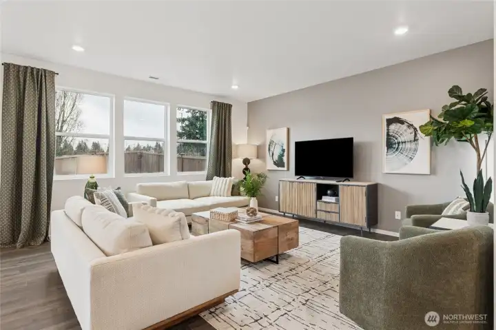 Open great room with large windows for natural light. Actual home is under construction and finishes, materials, and colors will vary. See site agent for details.