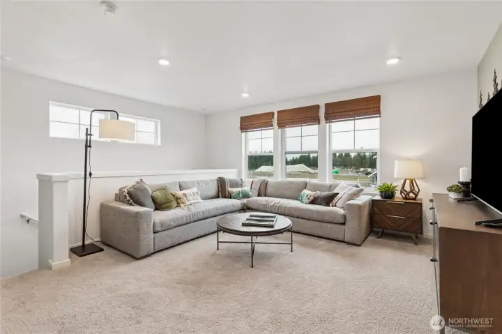 Large loft area perfect for media space, game room, or playroom. Actual home is under construction and finishes, materials, and colors will vary. See site agent for details.