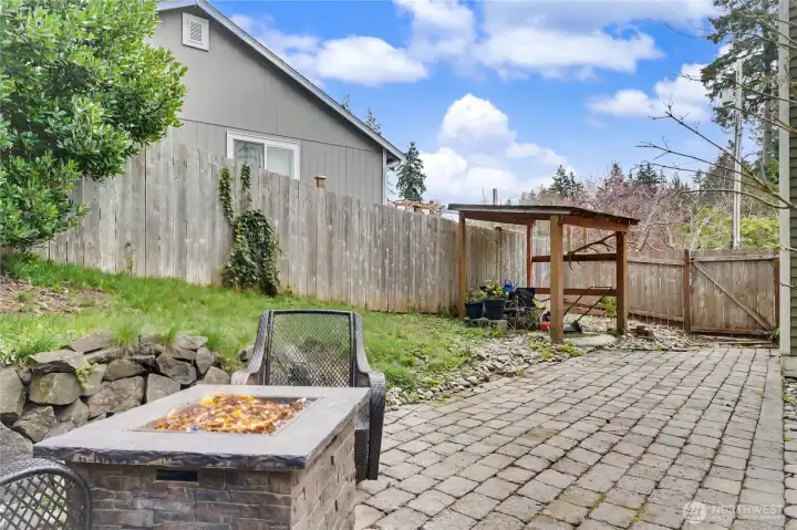 View of your side backyard, handy gate leading to your front yard, large patio pavers. SO much space to play, entertain, garden!