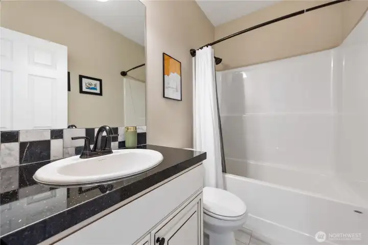 Guest bathroom with huge bathtub/shower combo.