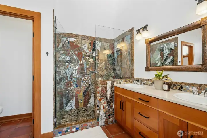 A statement primary bath with layered design elements.