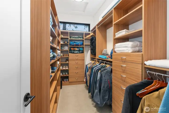 Primary Suites oversized walk-in closet with custom built-ins throughout!