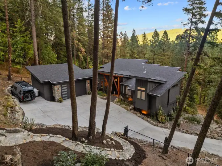 Concrete driveway, lights, wall & house number   Drive faces south, ice melts very quickly in winter   Autel Maxicharger Electric Vehicle (EV) Charger,240V   External house painted with Sherwin Williams    New gutters, leaf guard & heated wires with Hue Smart Plugs Smart Plug - allows for remote   access   3 x Google Nest Cam wired cameras & floodlights (electrical installed) Nest Cam with   Floodlight - Google Store   Philips Hue smart landscape lights Outdoor Lily Spot lights  |  Outdoor Calla Bollard Lights   Fencing around hillside & back yard with gates   Installed in semi-circle up the mountain to encourage animals to go either side   Roof cover over HVAC built & painted   Built path & gate from back yard to Private Road   Built path from Private Road to river & private beach – stabilized area with additional rocks