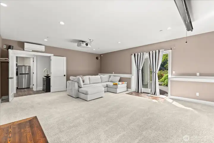 Huge media\family room with slider to patio and yard leading down to the lake Huge media\family room with slider to patio and yard leading down to the lake