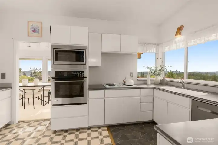The kitchen offers Corian countertops, illuminated display cabinetry, and ample workspace. The kitchen offers Corian countertops, illuminated display cabinetry, and ample workspace.