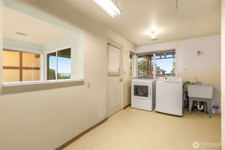 Enjoy a spacious laundry room featuring a window and sink, perfect for all your laundry needs. It offers plenty of space for crafts and hobbies. Enjoy a spacious laundry room featuring a window and sink, perfect for all your laundry needs. It offers plenty of space for crafts and hobbies.