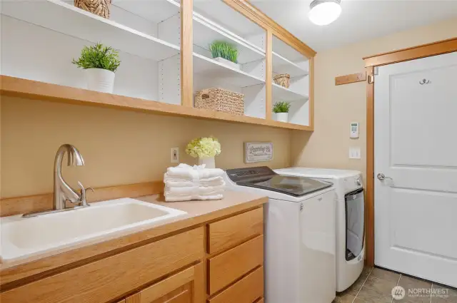 Even the laundry room has storage! Washer and dryer stay. There is a small pet door to garage, too.