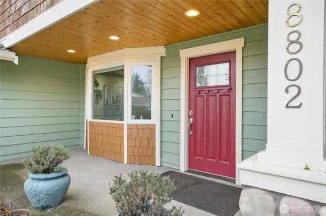 The well-lit, covered front porch reflects this home's craftsman style and includes a cedar ceiling.