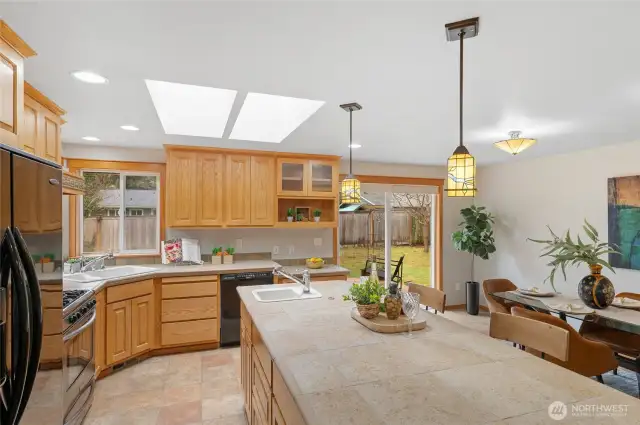 The kitchen is absolutely amazing! You will love spending time in this roomy Chef's space. Two sinks both with garbage disposals, large, eat-at center island. Corner windows look over the backyard.