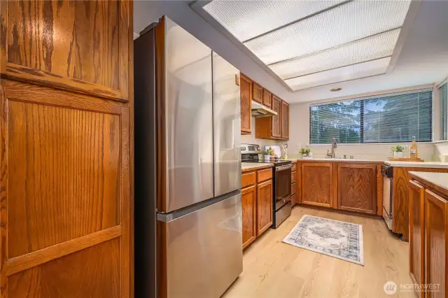 A convenient pantry sits just to the left of the refrigerator, offering additional space.