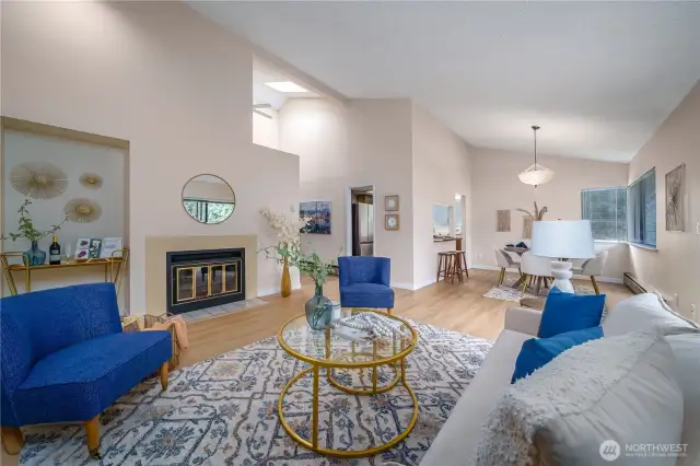 Back inside, a cozy wood-burning fireplace anchors the living space, which flows seamlessly into the dining room.