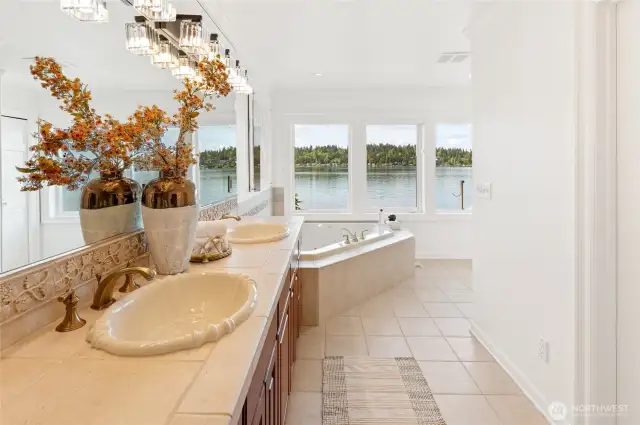 Beautiful primary bath with soaking tub to gaze out at the lake.
