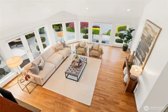 Wall of windows and vaulted ceilings bringing natural light to the living space.
