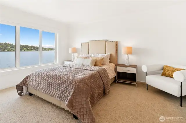 Sumptuous upper bedroom with expansive views of the lake & walk in closet.