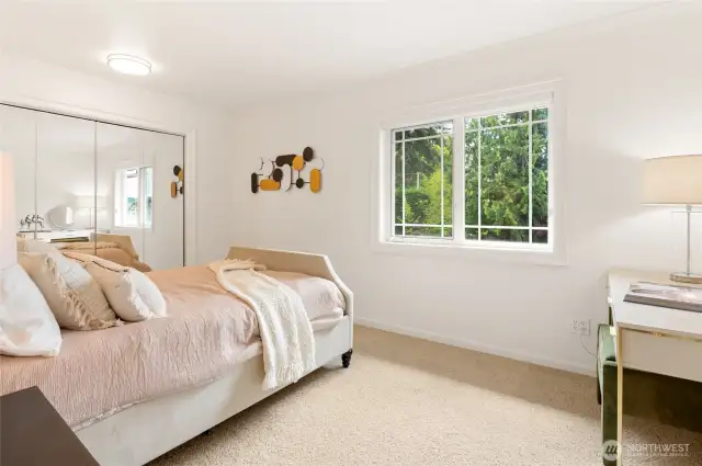 Upper floor bedroom with views of the lush greenery & mini golf course.