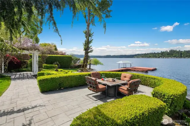 Expansive stamped patio that wraps around the house to the waterfront.