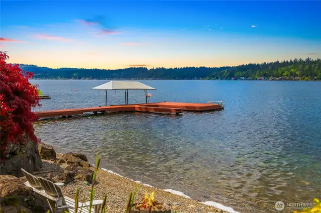 Exciting water sports await - a covered boat lift with boat slips and cleats to tie up your watercrafts, dive platform, and swim step and rail.